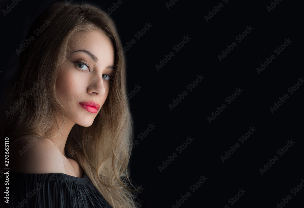 Beautiful ,young blonde with bright red lips and expressive eyes in a black jumpsuit. Beauty portrait of a girl. Emotional and bright appearance. Fashion portrait of a woman.
