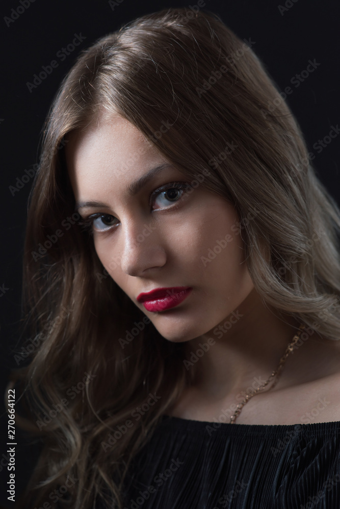 Beautiful ,young blonde with bright red lips and expressive eyes in a black jumpsuit. Beauty portrait of a girl. Emotional and bright appearance. Fashion portrait of a woman. Beautiful ,young blonde with bright red lips and expressive eyes in a black jumpsuit. Beauty portrait of a girl. Emotional and bright appearance. Fashion portrait of a woman.