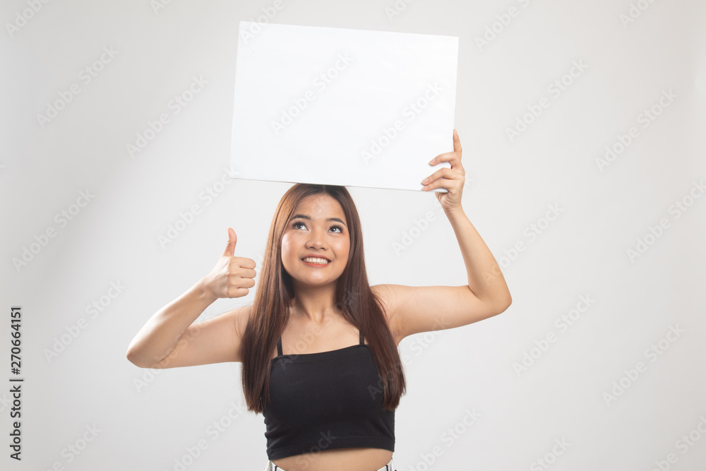 Young Asian woman show thumbs up with white blank sign. Young Asian woman show thumbs up with white blank sign.
