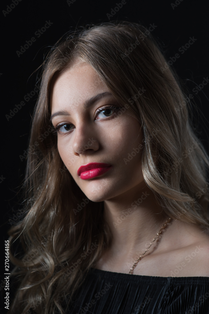 Beautiful ,young blonde with bright red lips and expressive eyes in a black jumpsuit. Beauty portrait of a girl. Emotional and bright appearance. Fashion portrait of a woman. Beautiful ,young blonde with bright red lips and expressive eyes in a black jumpsuit. Beauty portrait of a girl. Emotional and bright appearance. Fashion portrait of a woman.