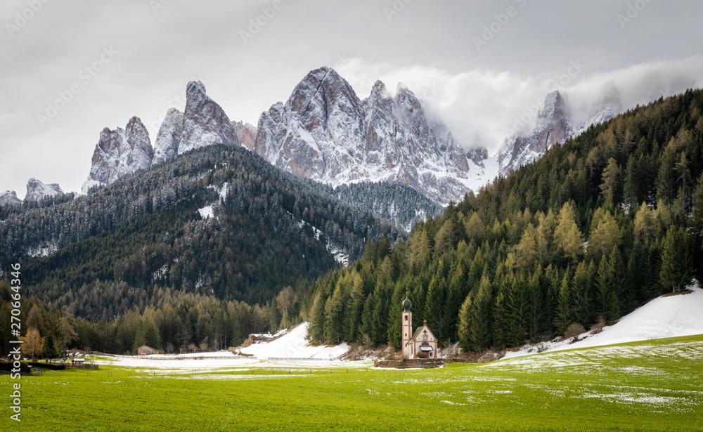 Snowy spring view on Church of St. Johann in Santa Magdalena, famous travel location Dolomite Alps, Italy
