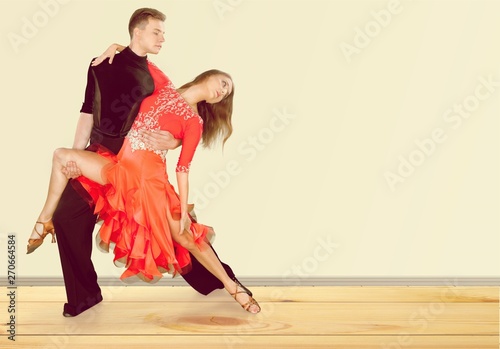 Man and a woman dancing Salsa on background