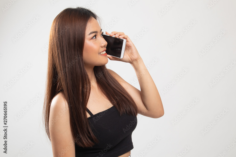 Young Asian woman talking with mobile phone. Young Asian woman talking with mobile phone.
