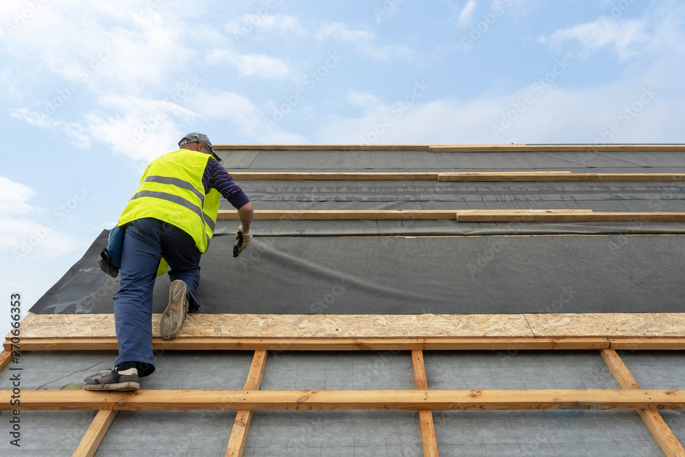 Building construction process of new wooden roof on wood frame house