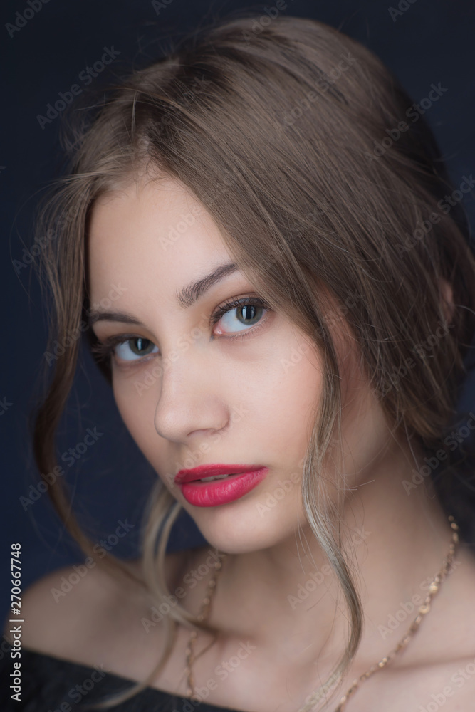Beautiful ,young blonde with bright red lips and expressive eyes in a black jumpsuit. Beauty portrait of a girl. Emotional and bright appearance. Fashion portrait of a woman. Beautiful ,young blonde with bright red lips and expressive eyes in a black jumpsuit. Beauty portrait of a girl. Emotional and bright appearance. Fashion portrait of a woman.