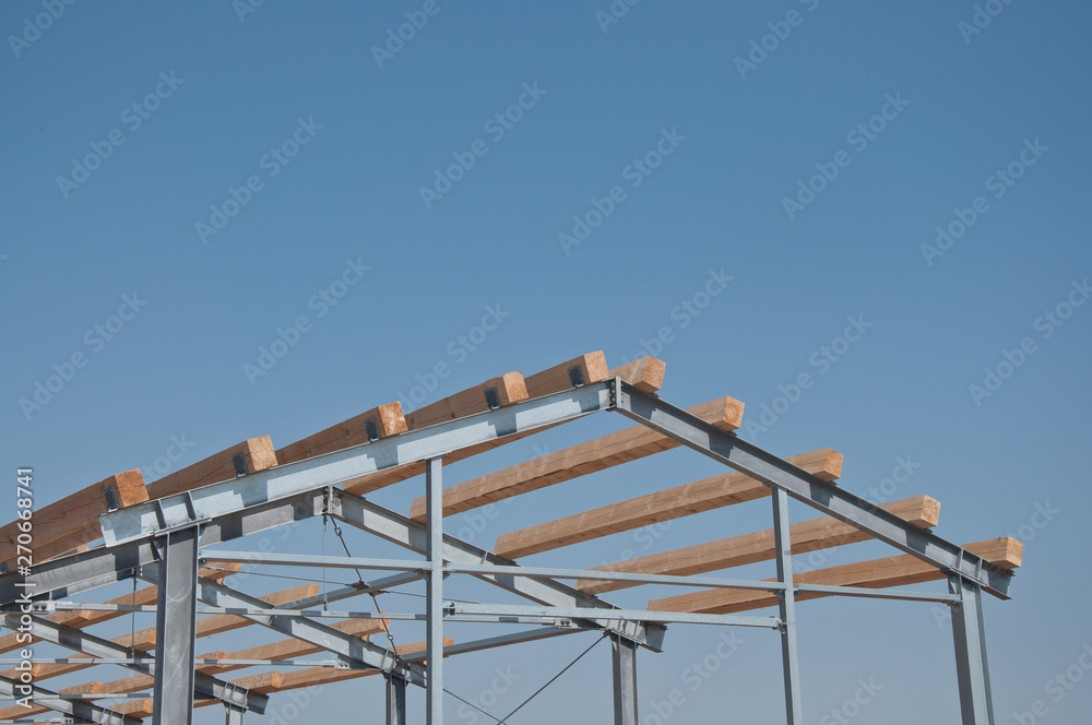Wooden beams on steel structure for further construction. Metal frame for the installation of insulation panels. Construction of pre-fabricated buildings.