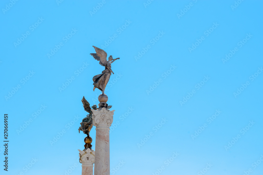 Winged woman statue in front of Altare della Patria, Piazza Venezia, Rome Italy