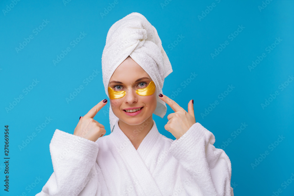 Image of woman with gel pads under eyes and towel on her head