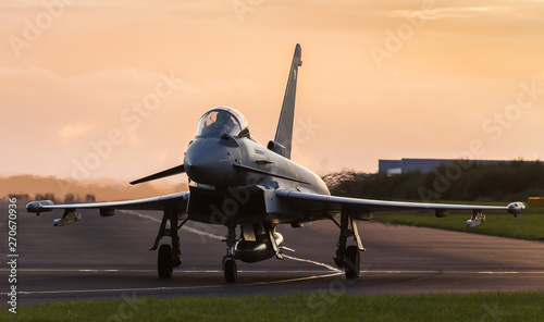 Backlit Typhoon taxis out for takeoff photo