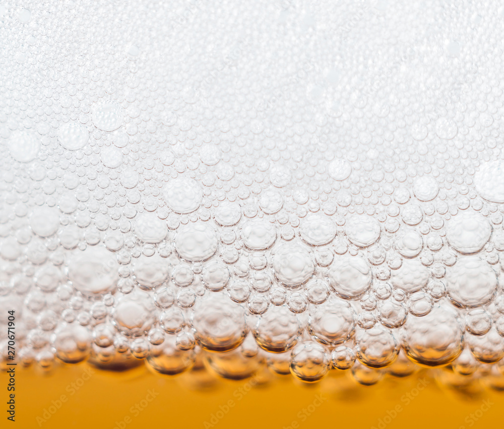beer bubbles in a glass of fresh amber beer
