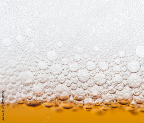 beer bubbles in a glass of fresh amber beer
