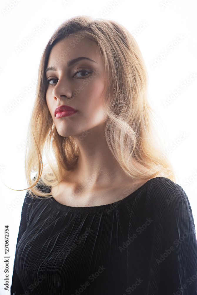 Beautiful ,young blonde with bright red lips and expressive eyes in a black jumpsuit. Beauty portrait of a girl. Emotional and bright appearance. Fashion portrait of a woman. Beautiful ,young blonde with bright red lips and expressive eyes in a black jumpsuit. Beauty portrait of a girl. Emotional and bright appearance. Fashion portrait of a woman.
