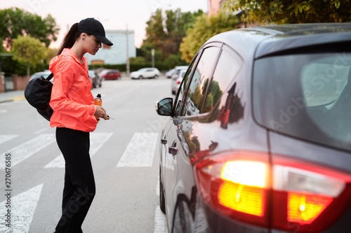 Woman With Key Walking Towards Car photo