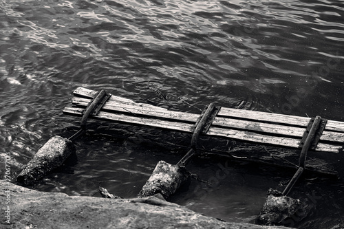 wooden bench taken by the water