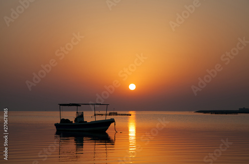 Sunrise at Asker beach with a boat, Bahrain