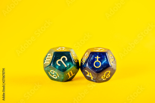 Astrology Dice with zodiac symbol of Aries Mar 21 - Apr 19 and its ruling planet Mars on Yellow Background