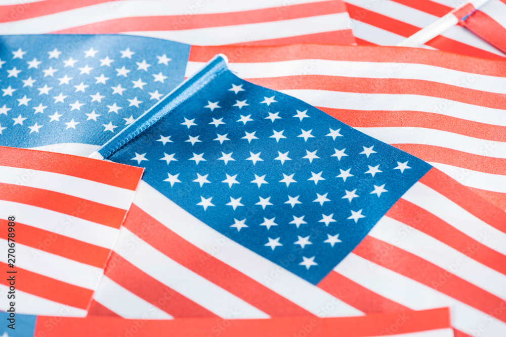 Fototapeta premium close up view of shiny national american flags in stack