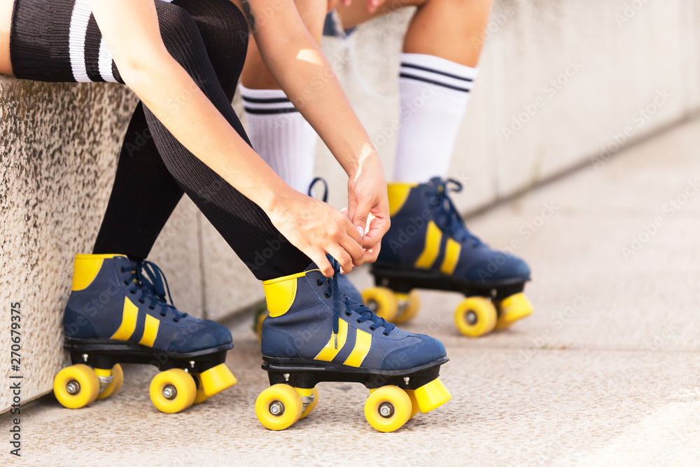 Girl tying rollerblade lace. Girl tying rollerblade lace.
