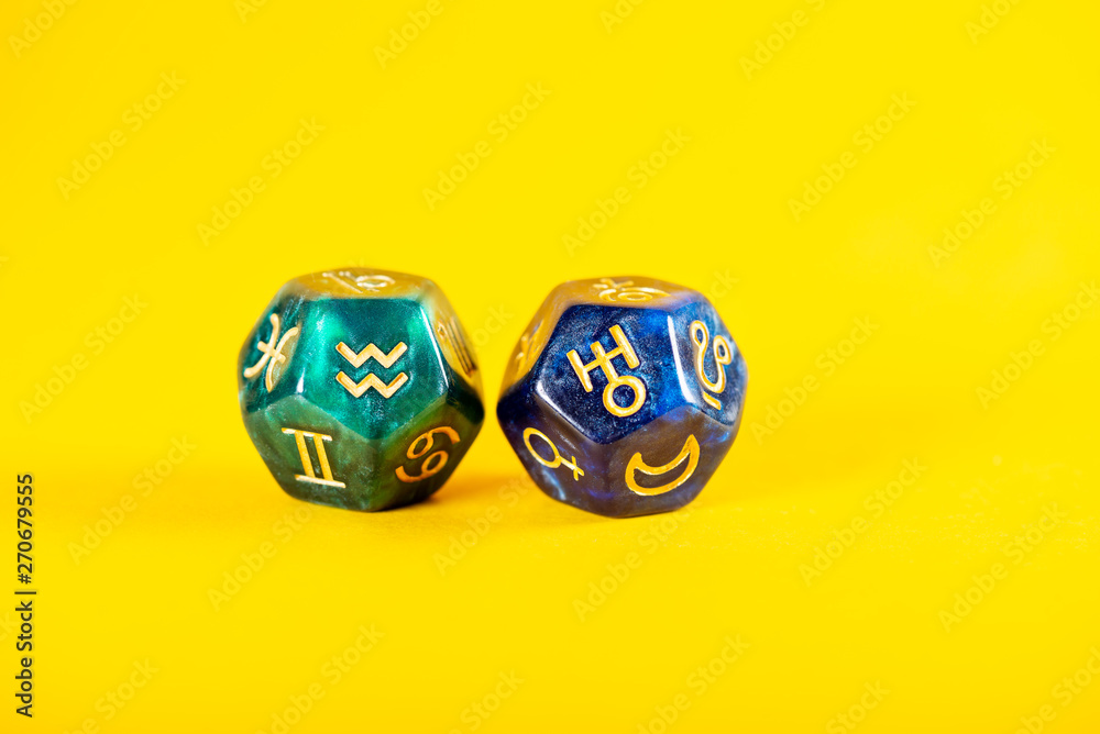 Astrology Dice with zodiac symbol of Aquarius Jan 20 - Feb 18 and its ruling planet Uranus on Yellow Background