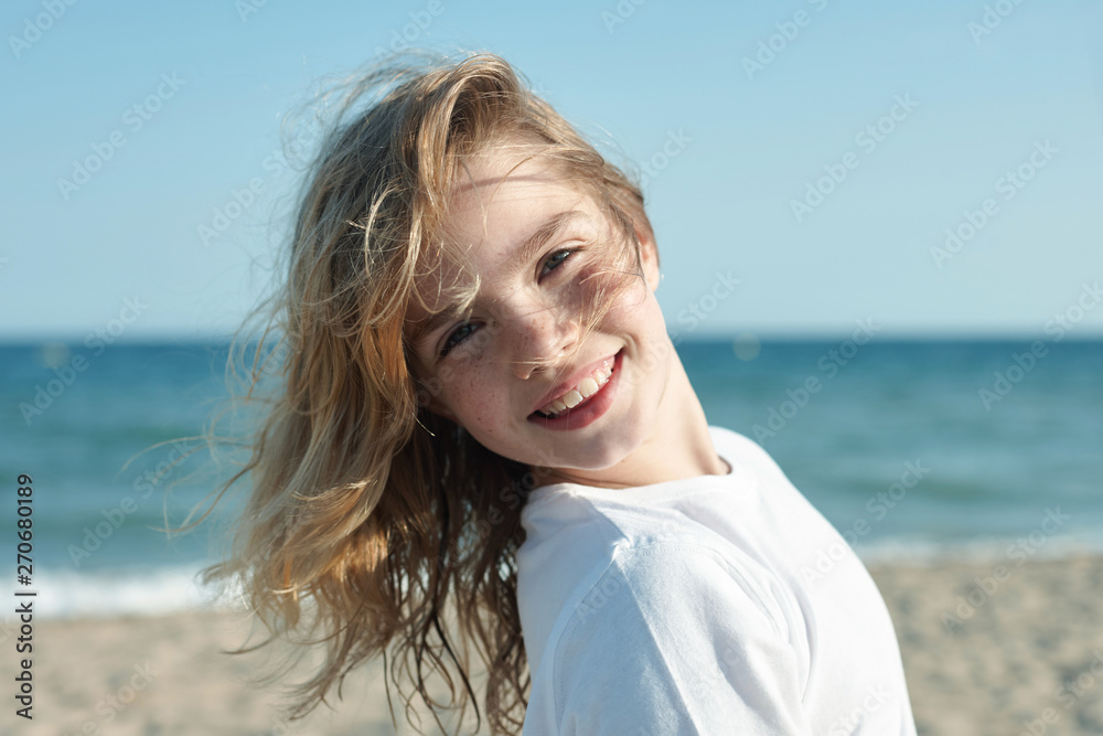 Portrait of a little girl smiling at the beach Stock Photo | Adobe Stock
