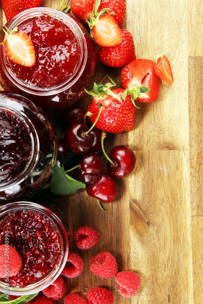assortment of jams, seasonal berries, cherry, mint and fruits in glass jar assortment of jams, seasonal berries, cherry, mint and fruits in glass jar
