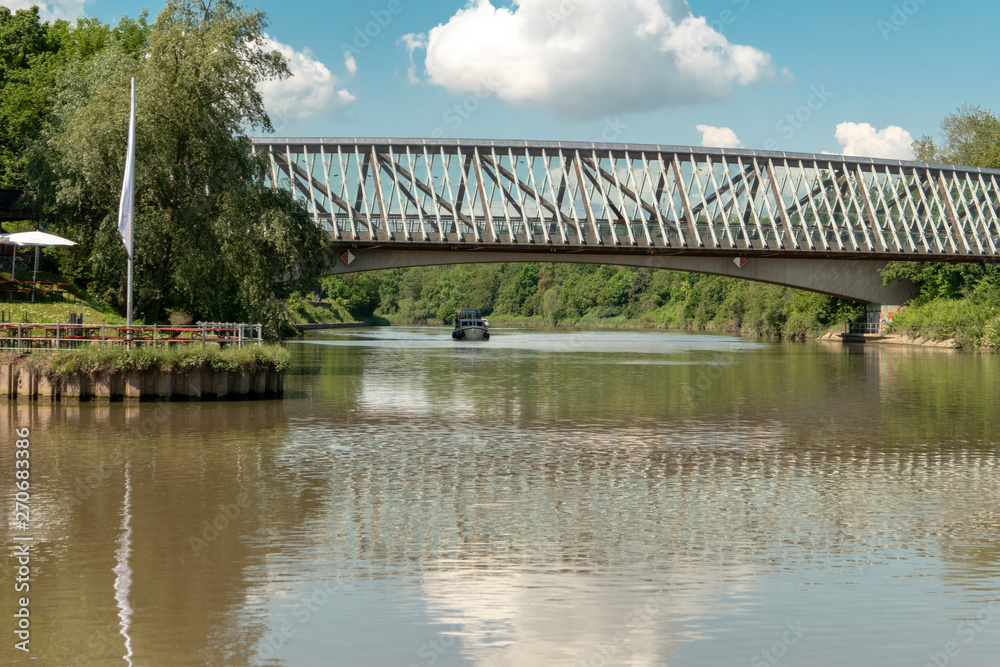 Fototapeta premium Bridge over the river Neckar with rib pattern and reflection on the river Neckar