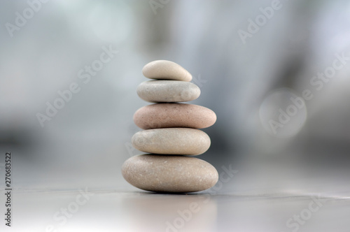Harmony and balance  cairns  simple poise pebbles on wooden light white gray background  simplicity rock zen sculpture