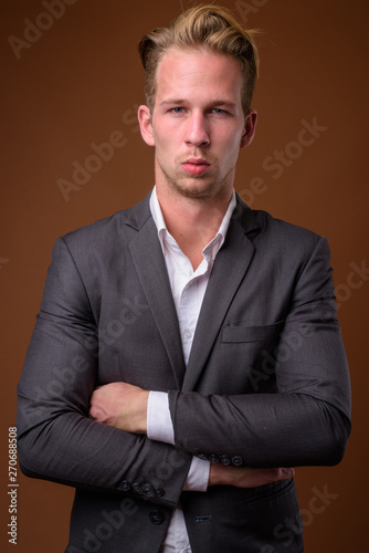 Studio portrait of young handsome businessman with suit