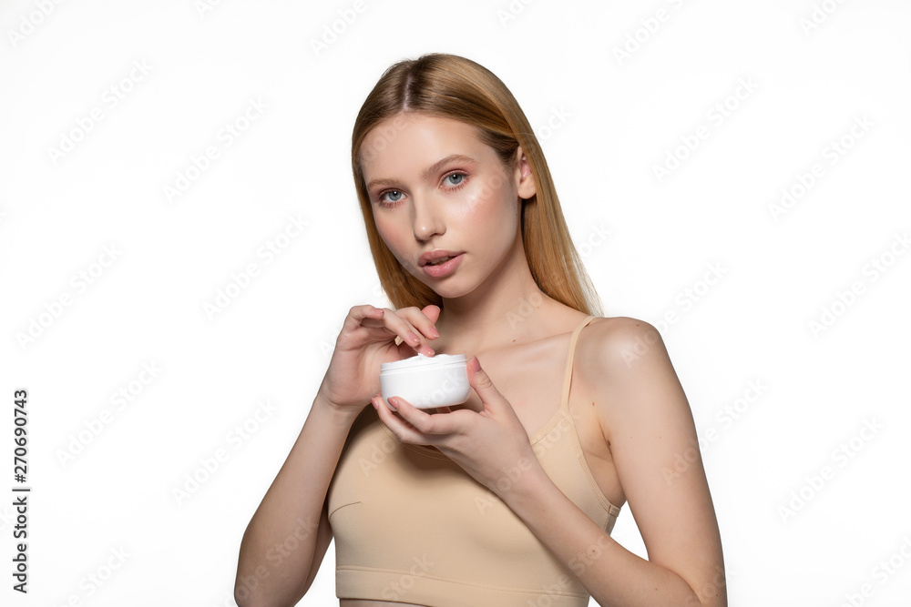 Photo of beautiful woman, close up studio on white background. Beauty female face with perfect make up. Holding cream for body and face Photo of beautiful woman, close up studio on white background. Beauty female face with perfect make up. Holding cream for body and face