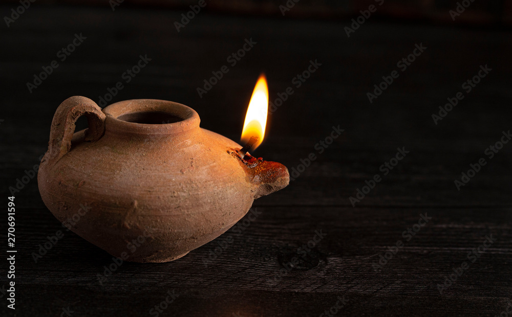 A Lit Handmade Oil Lamp from the Middle East on a Dark Table Stock Photo |  Adobe Stock
