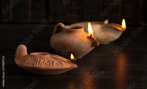 Lit Handmade Oil Lamp from the Middle East on a Dark Table