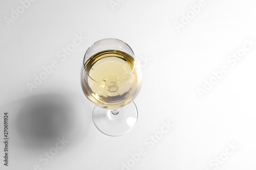 Glass of wine on white background, above view. Space for text photo