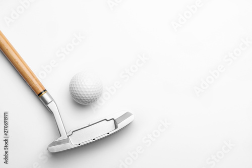 Golf ball and club on white background. Sport equipment
