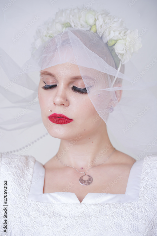 pretty curvy adult woman with short hair wearing long vintage wedding dress with sun style skirt. young caucasian bride with veil on white studio background alone. pretty curvy adult woman with short hair wearing long vintage wedding dress with sun style skirt. young caucasian bride with veil on white studio background alone.
