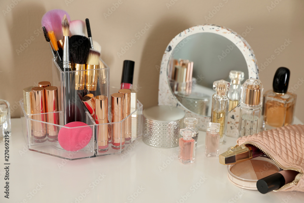 Luxury makeup products and accessories on dressing table with mirror near  wall Stock Photo | Adobe Stock