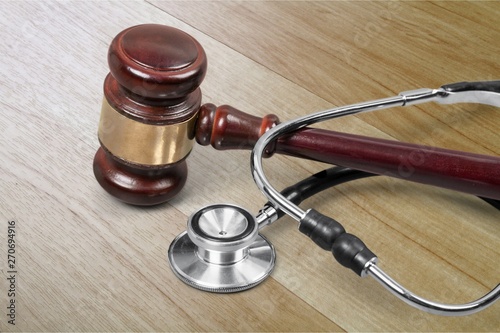Gavel and stethoscope  on background  symbol photo for bungling and medical error