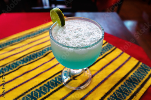 Lemonade, lemon liquados in glas on table with traditional striped cloth, Lago Atitlan, Guatemala photo