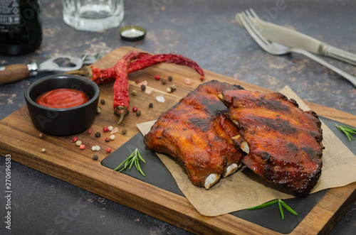 Grilled pork ribs on wooden board. Smoked barbecue pork spare ribs 