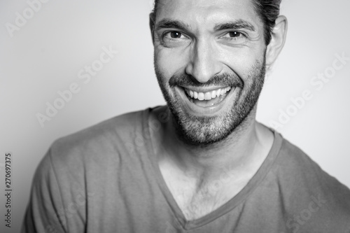 BW portrait of a caucasian young man smiling at the camera