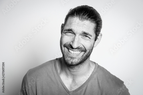 BW portrait of a caucasian young man with funny expression of disgust
