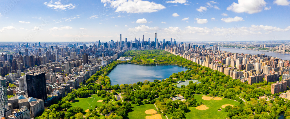 Central Park aerial view, Manhattan, New York. Park is surrounded by skyscraper. Beautiful view of the Jacqueline Kennedy Onassis Reservoir in the center of the park.