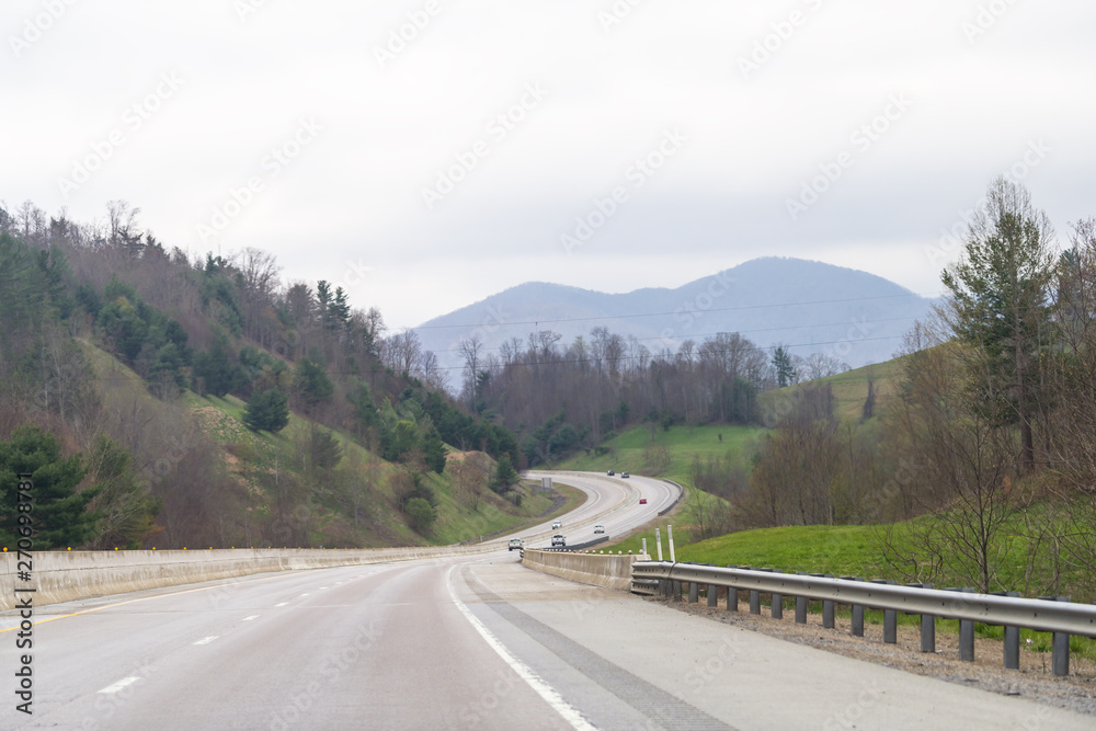 Smoky Mountains near Asheville, North Carolina at Tennessee border during spring day sky trees on South 25 highway road with cars