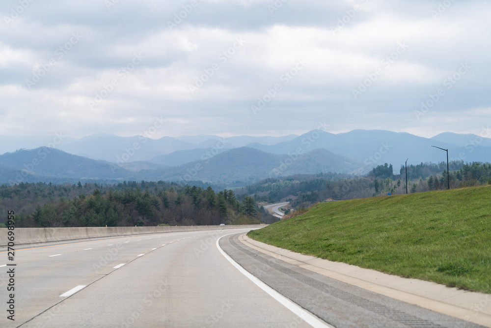 Smoky Mountains near Asheville and Tennessee border with cloudy sky and forest trees on South 25 highway road Smoky Mountains near Asheville and Tennessee border with cloudy sky and forest trees on South 25 highway road