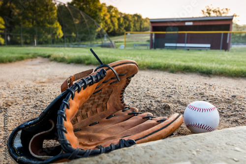 Baseball and glove on pitchers mound on early morning springtime © rabbitti