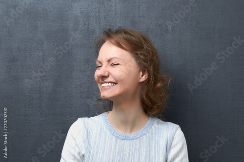 Portrait of happy young woman laughing broadly