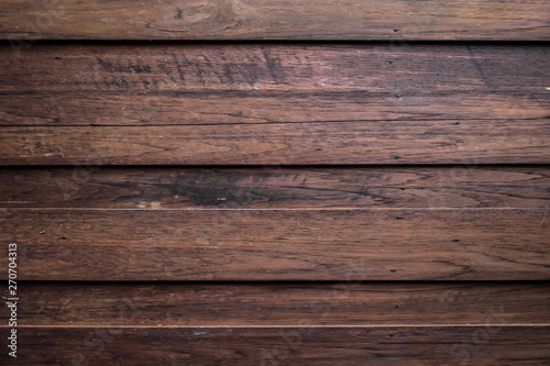 Close-up of wall made of wooden planks. Old dark brown wooden wall background texture.