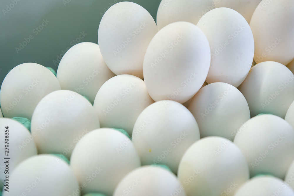 The stack of many white chicken eggs The stack of many white chicken eggs
