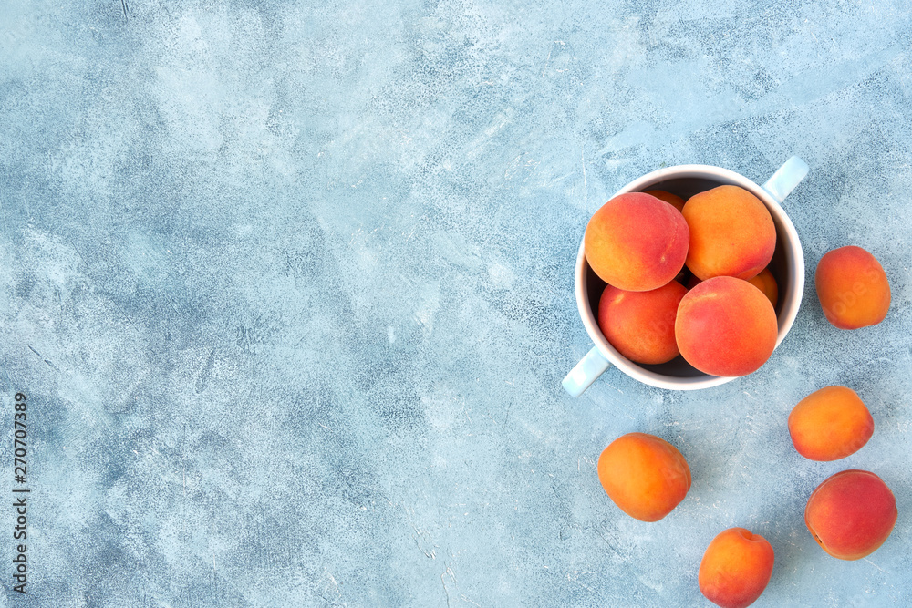 Fresh apricots in a bowl. Top view, copy space  