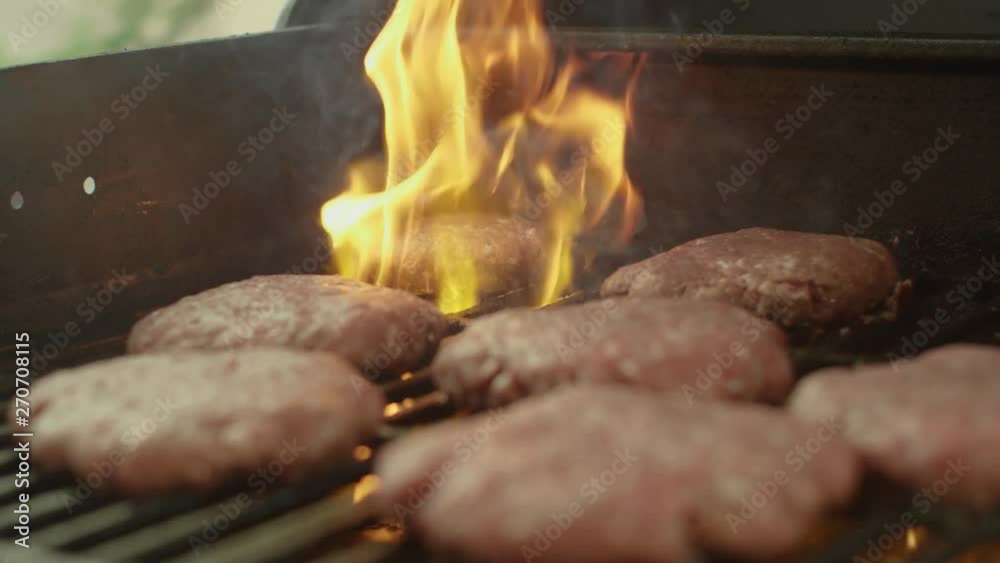 Grilling Burgers on Gas Grill, Flames. 4k 75 FPS Slow Motion Grilling Burgers on Gas Grill, Flames. 4k 75 FPS Slow Motion