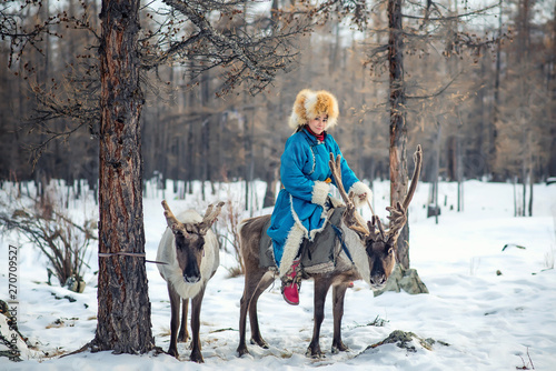 Beautiful portrait of Mongolian Reindeer Tsaatan family on their reindeers at Taiga, Mongolia photo